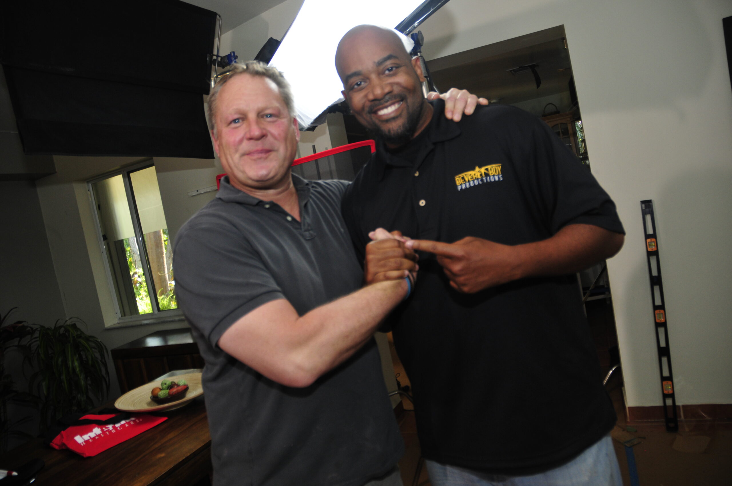 Tavares Beverly shaking hands with clients on a video production set